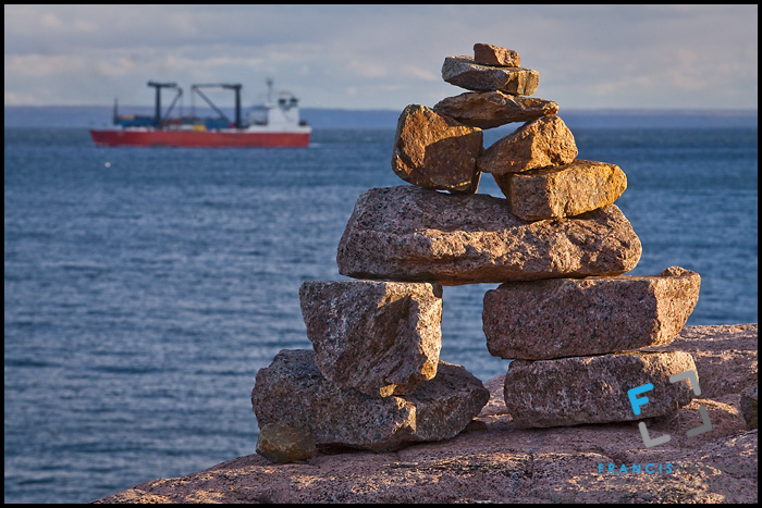 Inuksuk overlooking the St. Lawrence river in Essipit
