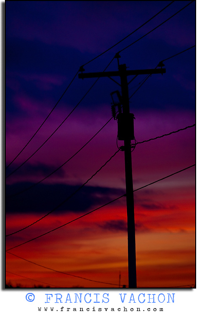 Sunset and silhouetted power transmission lines