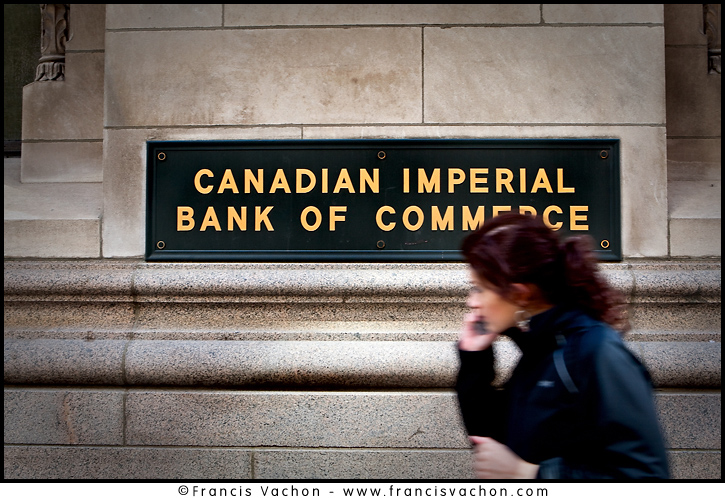 A woman talking on her cell phone walks by a Canadian Imperial Bank of Commerce office in Toronto financial district April 19, 2010. The Canadian Imperial Bank of Commerce (in French, Banque Canadienne Imperiale de Commerce, and commonly CIBC in either language) is one of Canada's chartered banks, fifth largest by deposits. 