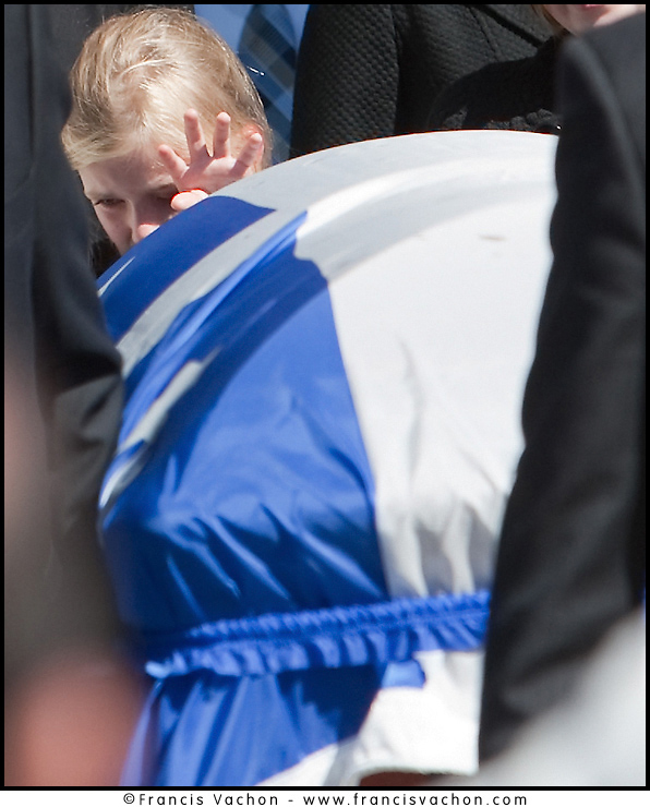 One of Claude Bechard children reaches for his coffin as it is carried out of the Sainte-Anne Cathedral in La Pocatiere Saturday September 11, 2010. Bechard passed away at 41 of a cancer