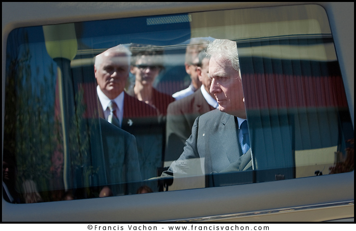 Quebec Premier Jean Charest is framed through the hearse's window as he touches Claude Bechard' coffin at the Sainte-Anne Cathedral in La Pocatiere Saturday September 11, 2010. Bechard passed away at 41 of a cancer 